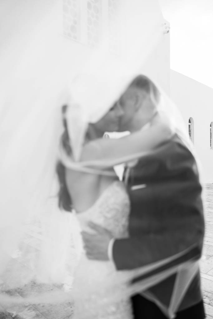 Intimate black and white portrait of newlyweds after ceremony.